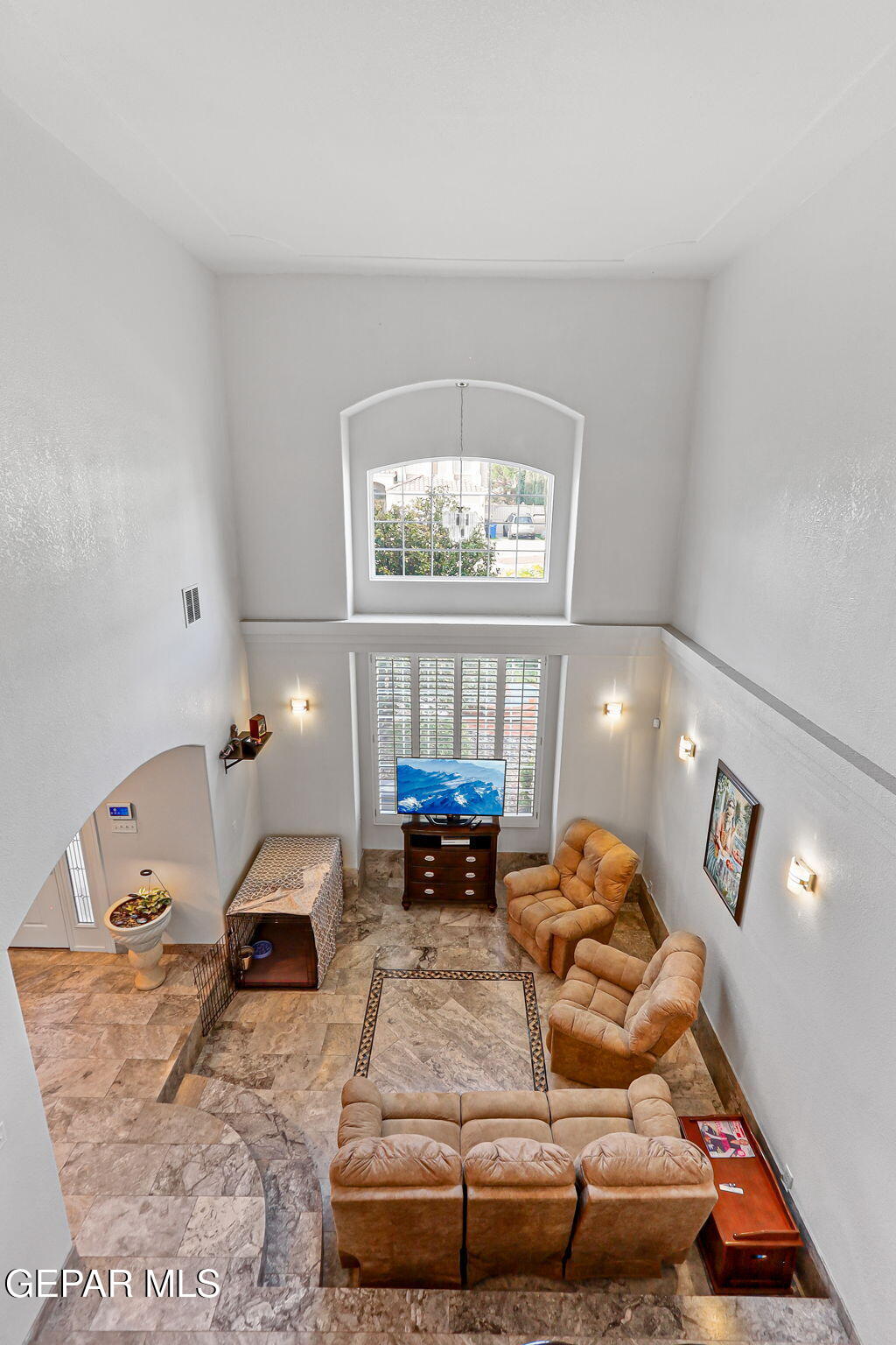 6544 Royal Ridge Drive El Paso, TX 79912 - Photo 40 of 58 a living room with furniture and a chandelier