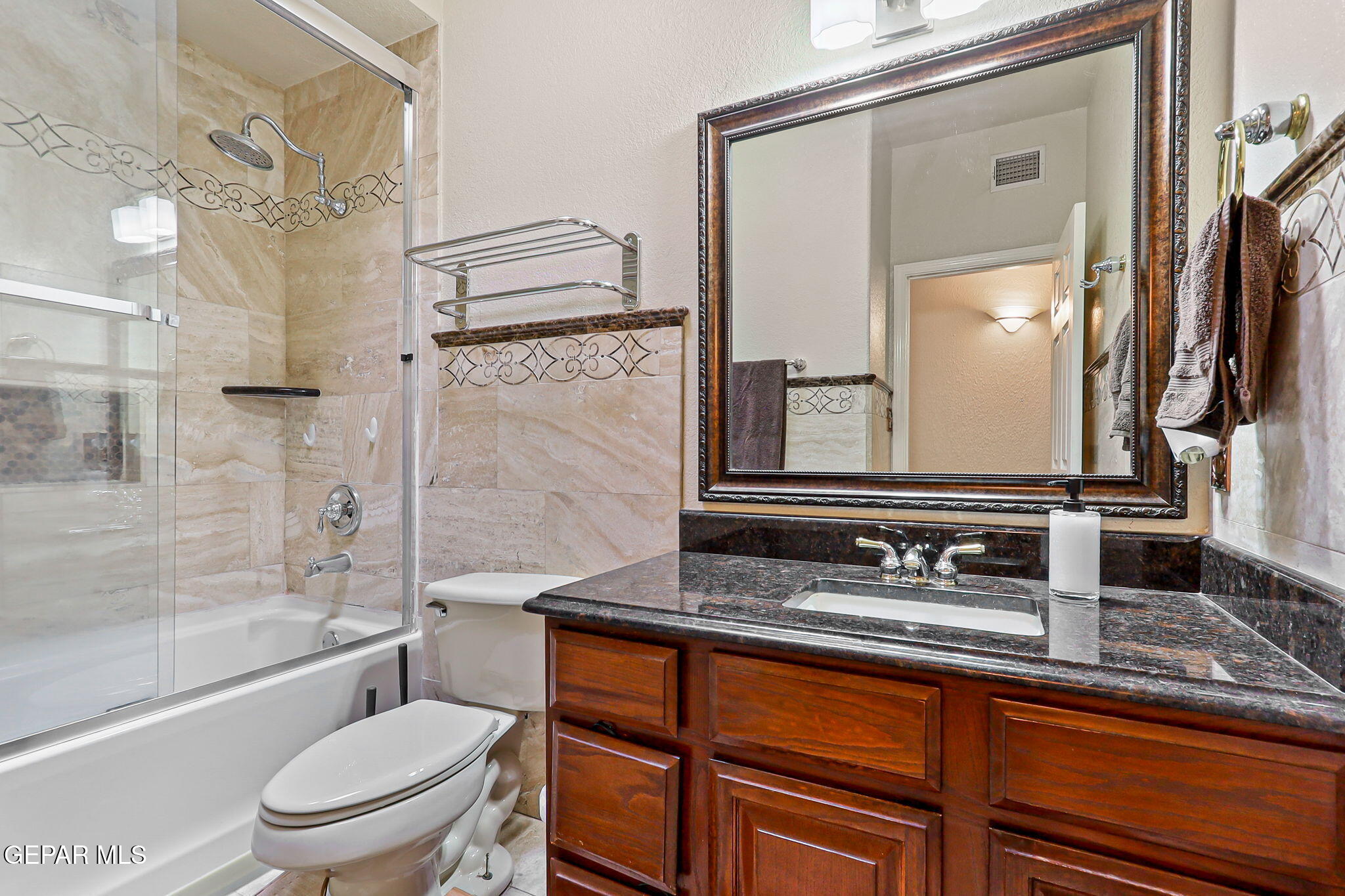 6544 Royal Ridge Drive El Paso, TX 79912 - Photo 43 of 58 a bathroom with a granite countertop sink toilet and shower