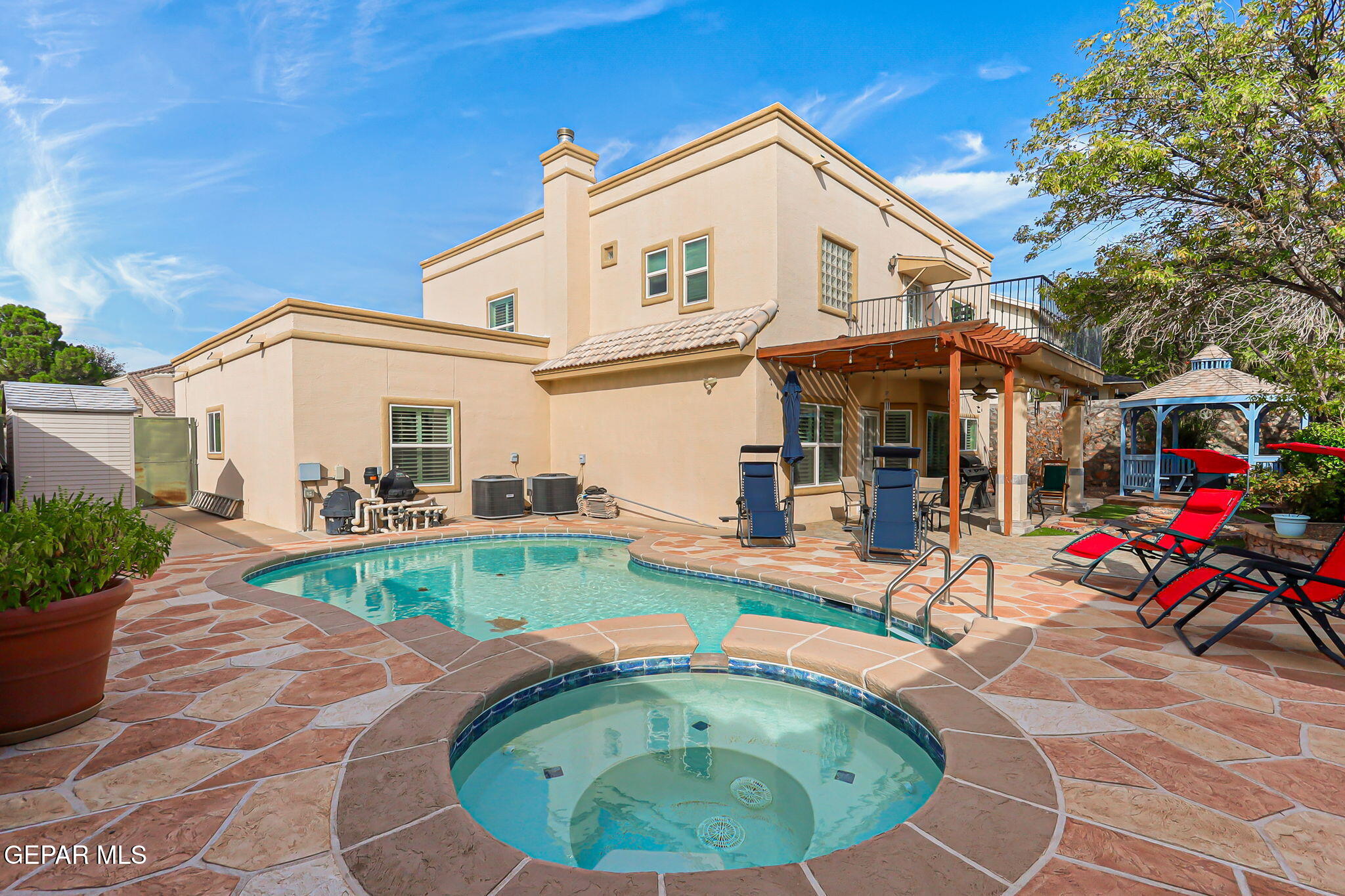 6544 Royal Ridge Drive El Paso, TX 79912 - Photo 49 of 58 a view of a white house with a swimming pool