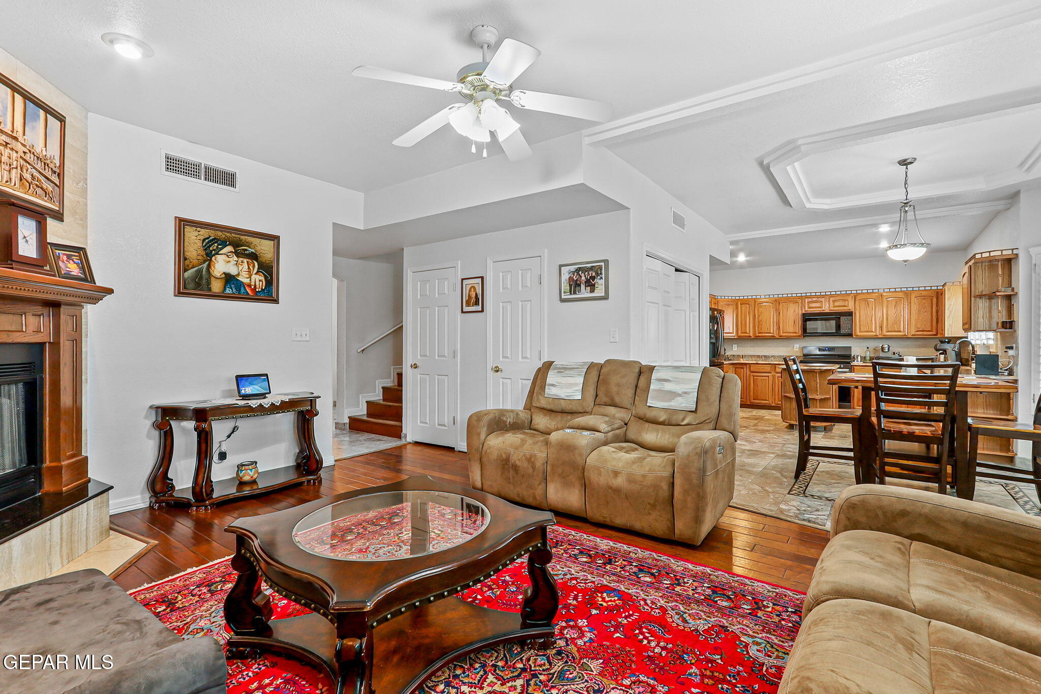 6544 Royal Ridge Drive El Paso, TX 79912 - Photo 7 of 58 a living room with furniture a ceiling fan and a rug