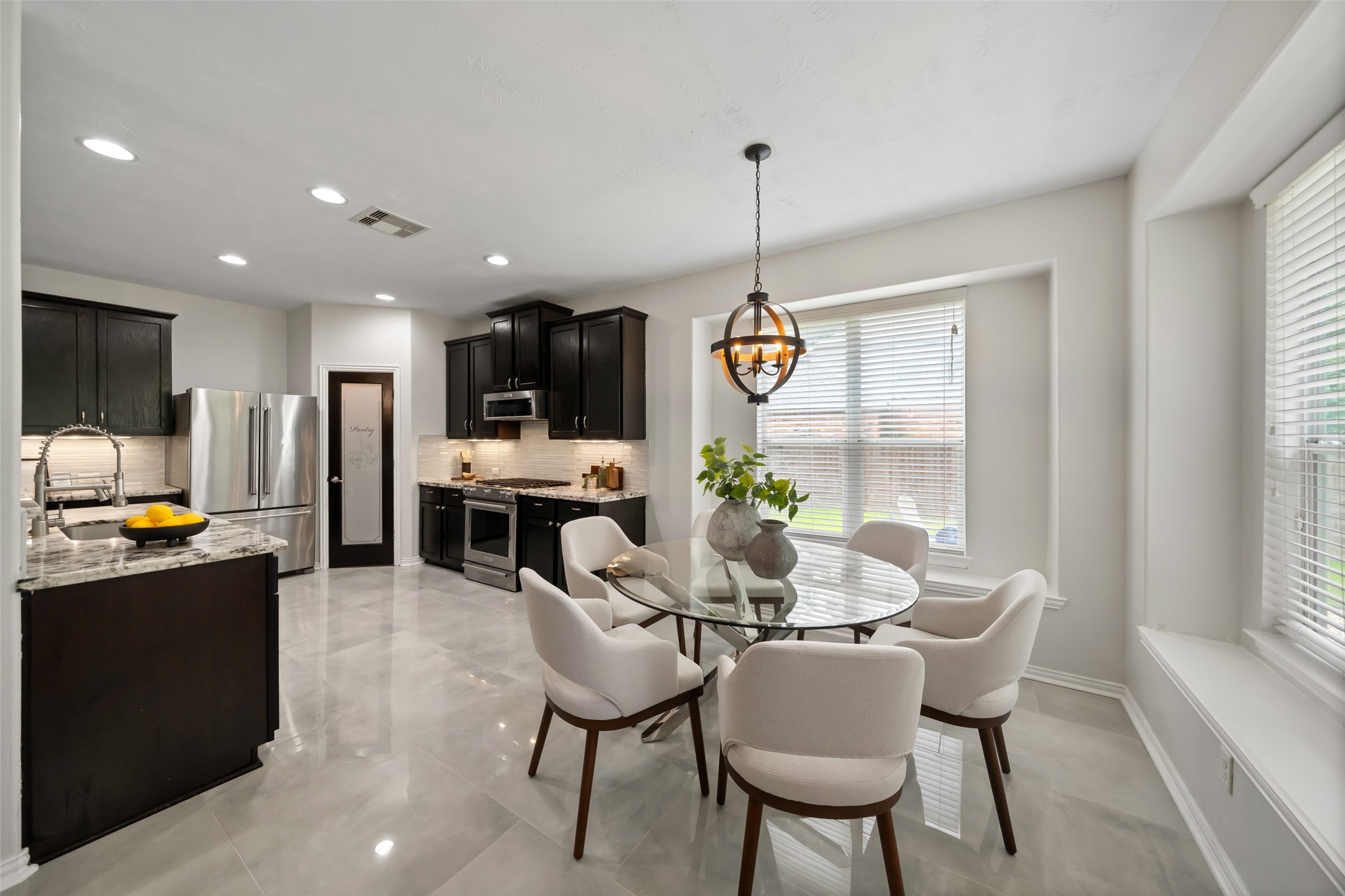 81 Palos Verde Conroe, TX 77304 - Photo 13 of 36 Breakfast room & kitchen, notice the bench seats & updated light fixtures