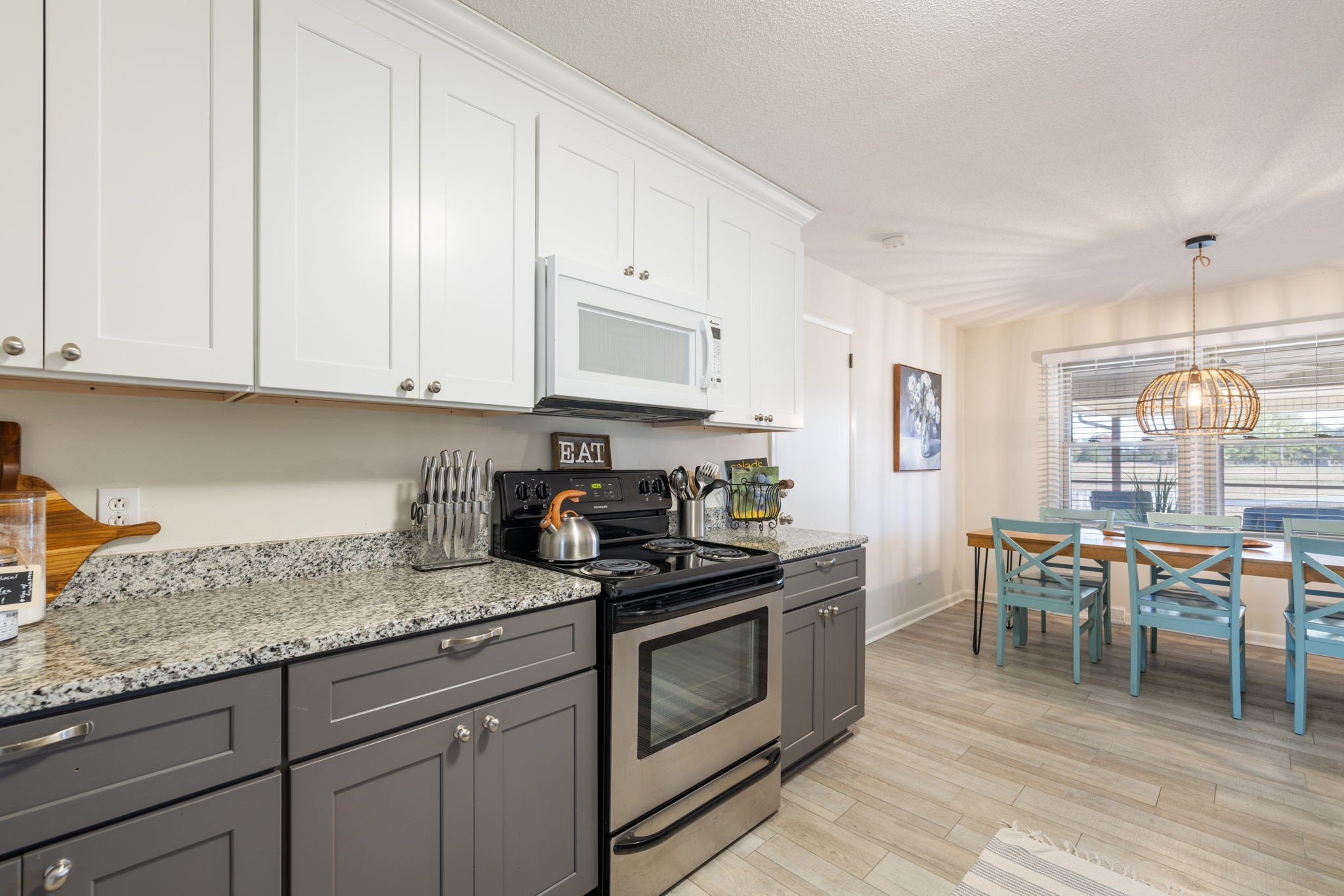 1755 Mc Bride Road Lewisburg, TN 37091 - Photo 18 of 59 a kitchen with granite countertop a stove top oven a sink a dining table and chairs