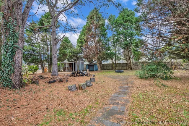 a view of a backyard with a table and chairs under an umbrella