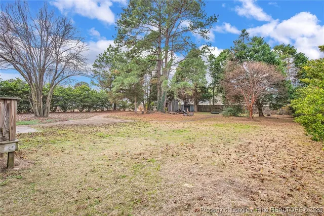 a view of yard with tree in the background