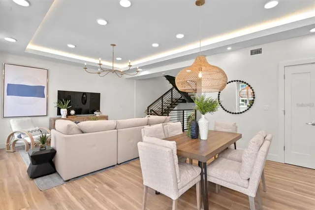a dining room with furniture and wooden floor