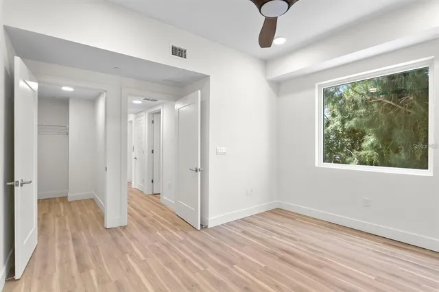 a view of entryway and hall with wooden floor