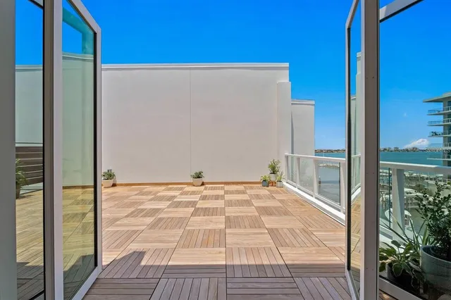 a dining room with furniture a potted plant and a window