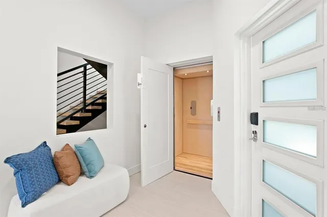 a large white bed in a white room