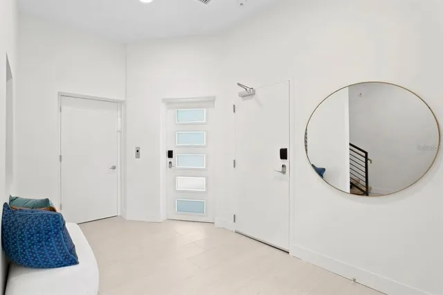 a hallway with couch and white walls