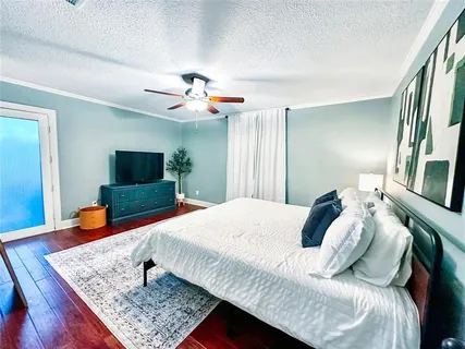 a bedroom with a bed and a flat screen tv