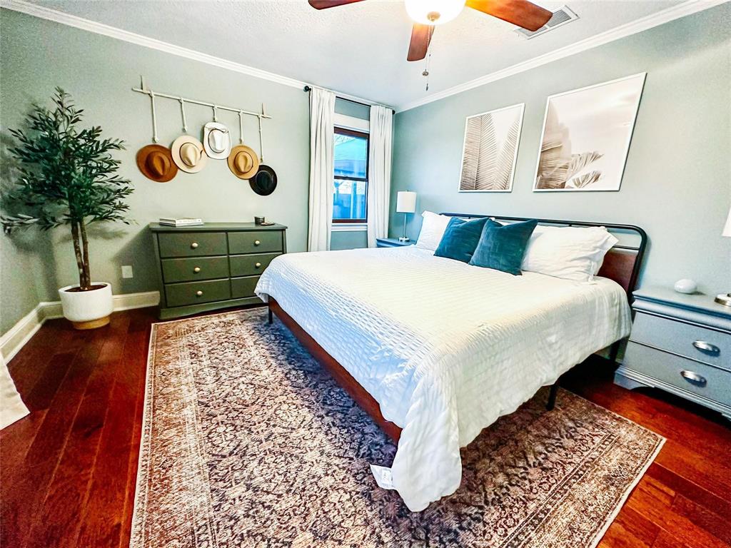 1114 Northwest 14th Street Grand Prairie, TX 75050 - Photo 13 of 19 a bed sitting in a bedroom next to a window