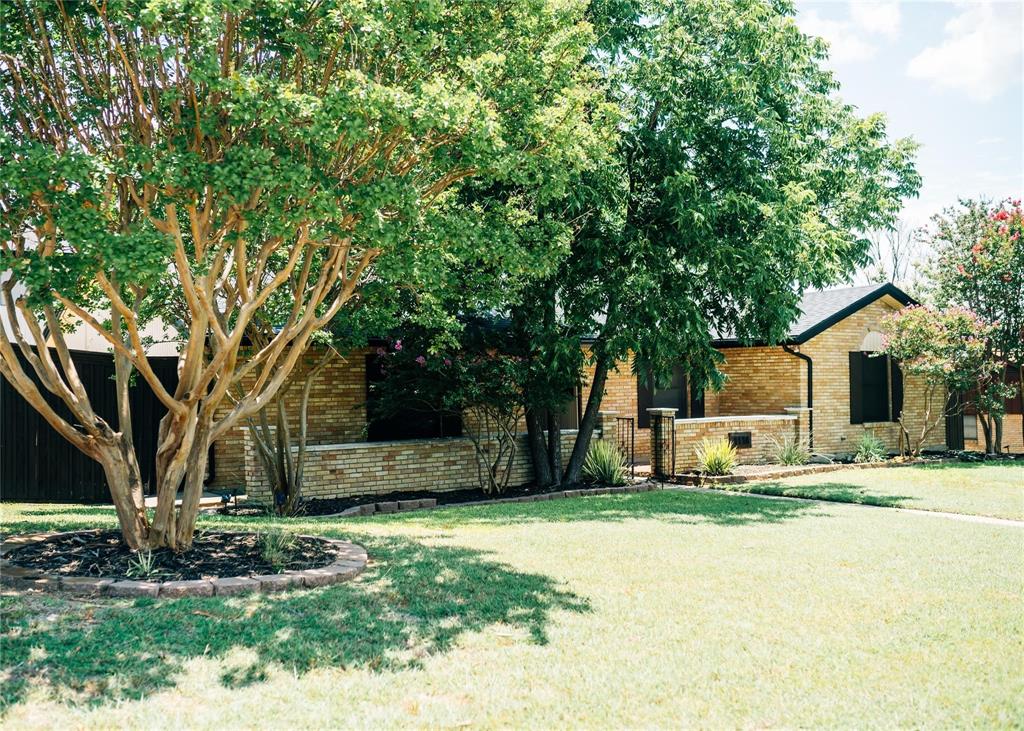 1114 Northwest 14th Street Grand Prairie, TX 75050 - Photo 3 of 19 a view of a house with a tree in front of it