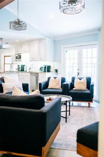 a living room with furniture and a chandelier