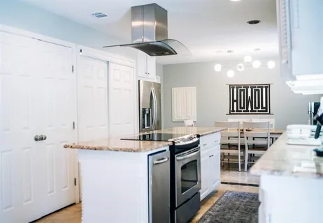 a kitchen with stainless steel appliances granite countertop a stove and a sink