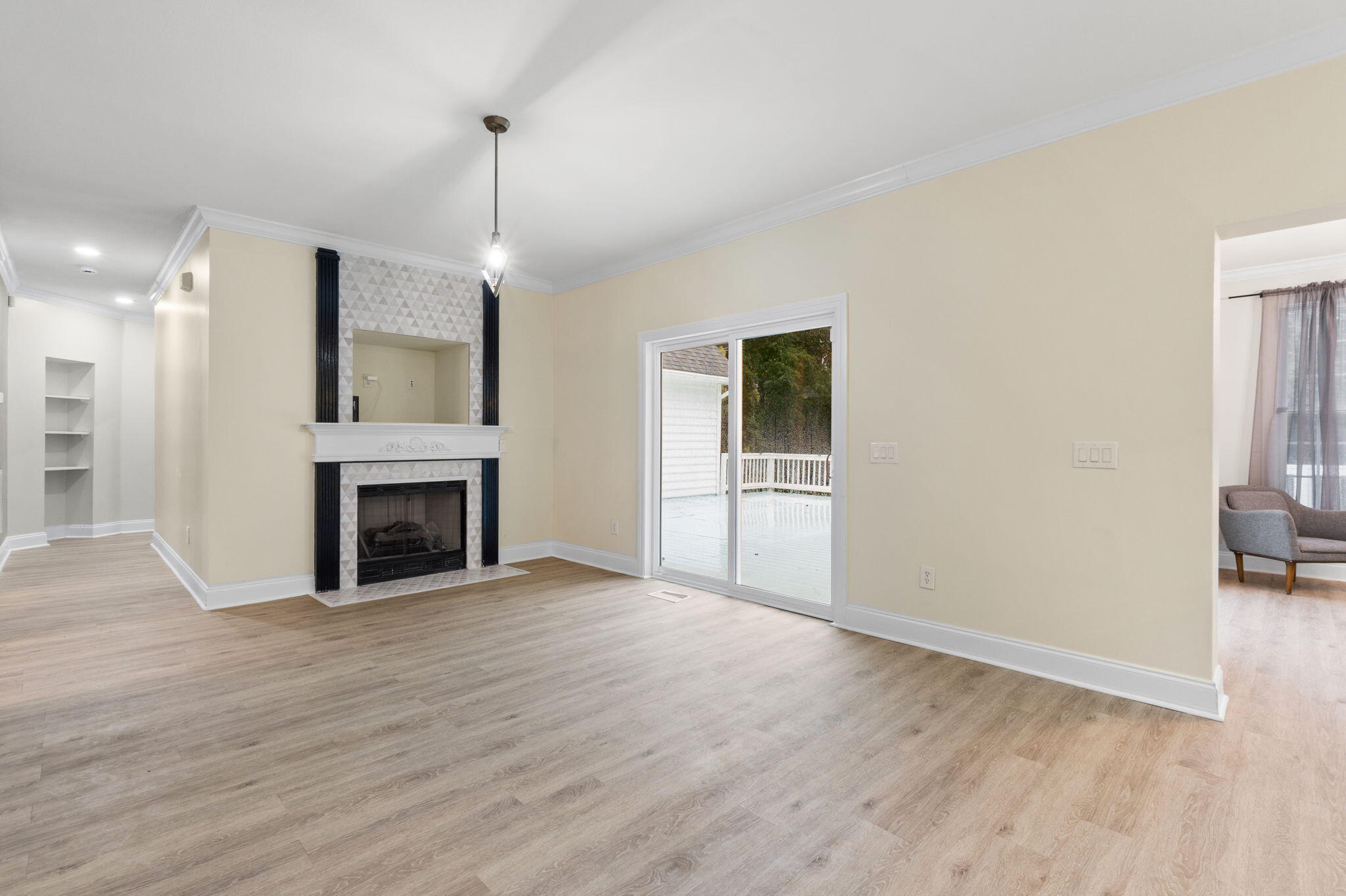 117 Santa Barbara Avenue Santa Rosa Beach, FL 32459 - Photo 15 of 116 a view of an empty room with wooden floor fireplace and a window