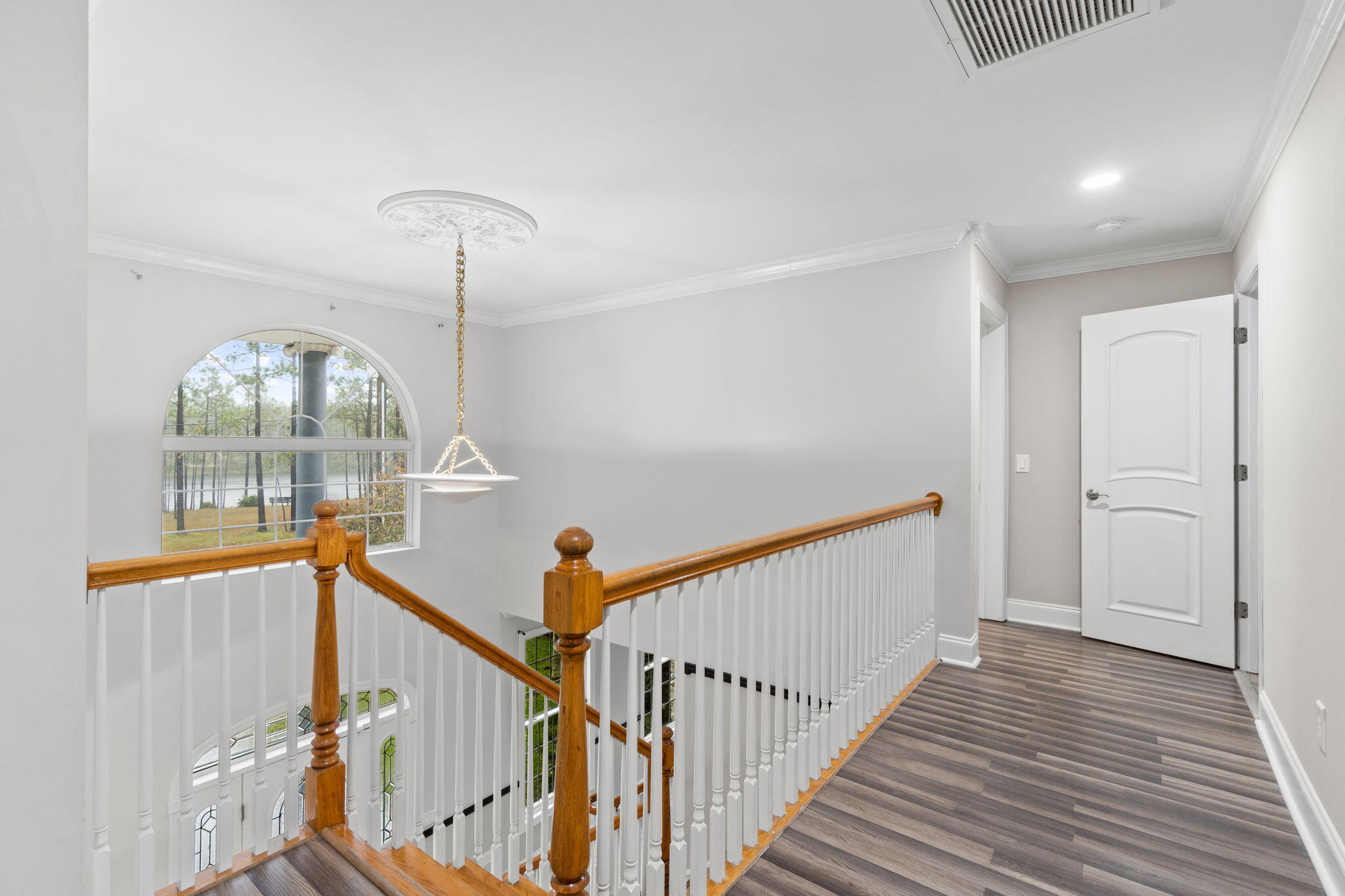 117 Santa Barbara Avenue Santa Rosa Beach, FL 32459 - Photo 38 of 116 a view of a hallway with wooden floor and staircase