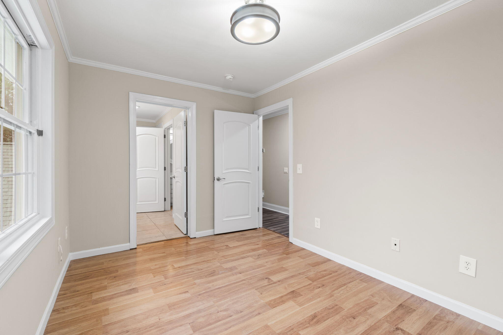 117 Santa Barbara Avenue Santa Rosa Beach, FL 32459 - Photo 41 of 116 an empty room with wooden floor and windows