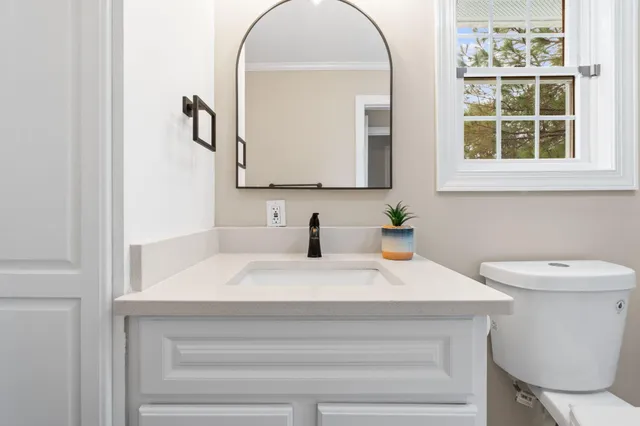 a kitchen with stainless steel appliances granite countertop stove a sink dishwasher a refrigerator and a dining table with wooden floor