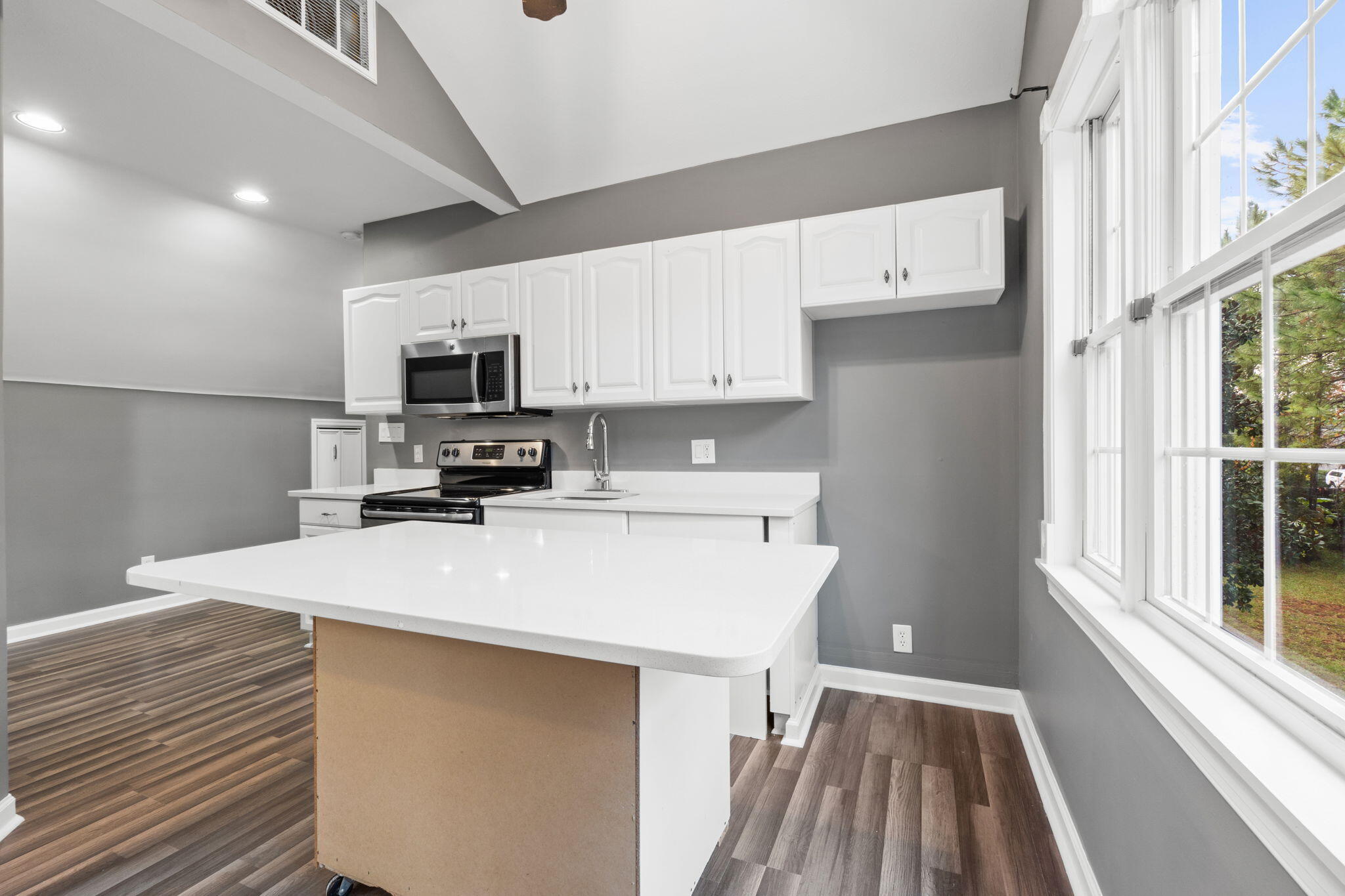117 Santa Barbara Avenue Santa Rosa Beach, FL 32459 - Photo 59 of 116 a kitchen with a sink a microwave a refrigerator and cabinets