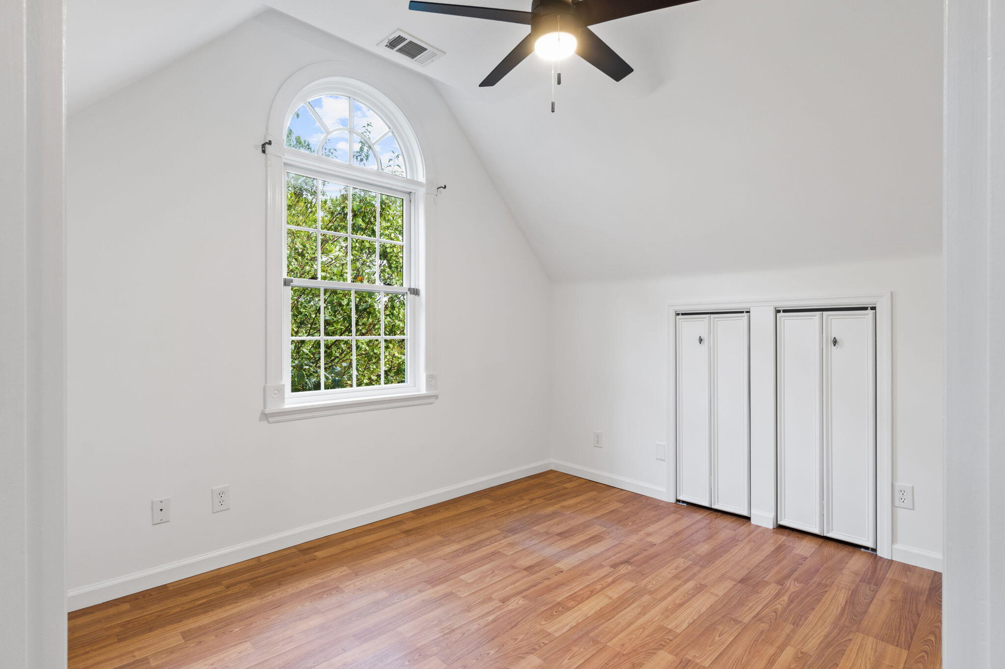 117 Santa Barbara Avenue Santa Rosa Beach, FL 32459 - Photo 62 of 116 an empty room with wooden floor fan and windows