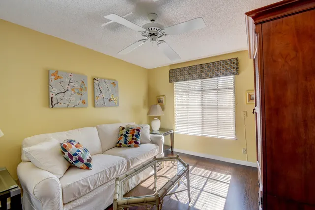 a bedroom with a large bed and wooden floor