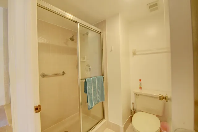 a living room with furniture a flat screen tv and a floor to ceiling window