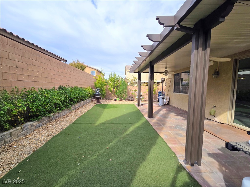 10855 Casco Bay Street Las Vegas, NV 89179 - Photo 48 of 64 Fenced backyard featuring a patio area and a ceiling fan
