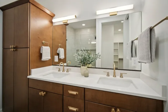 a bathroom with a double vanity sink mirror and double