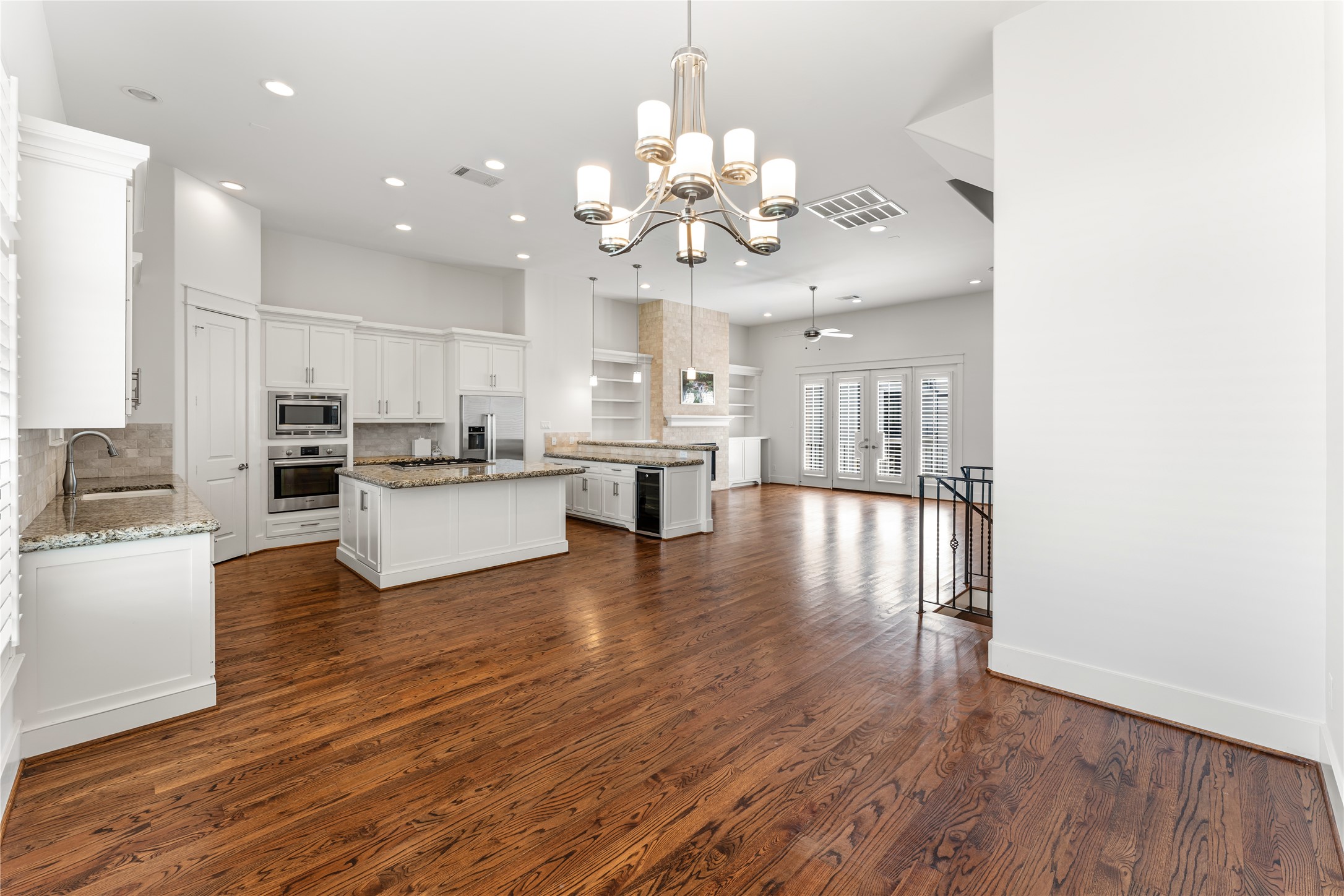 4938 Edison Park Lane Houston, TX 77081 - Photo 13 of 49 an open kitchen with wooden floor and stainless steel appliances