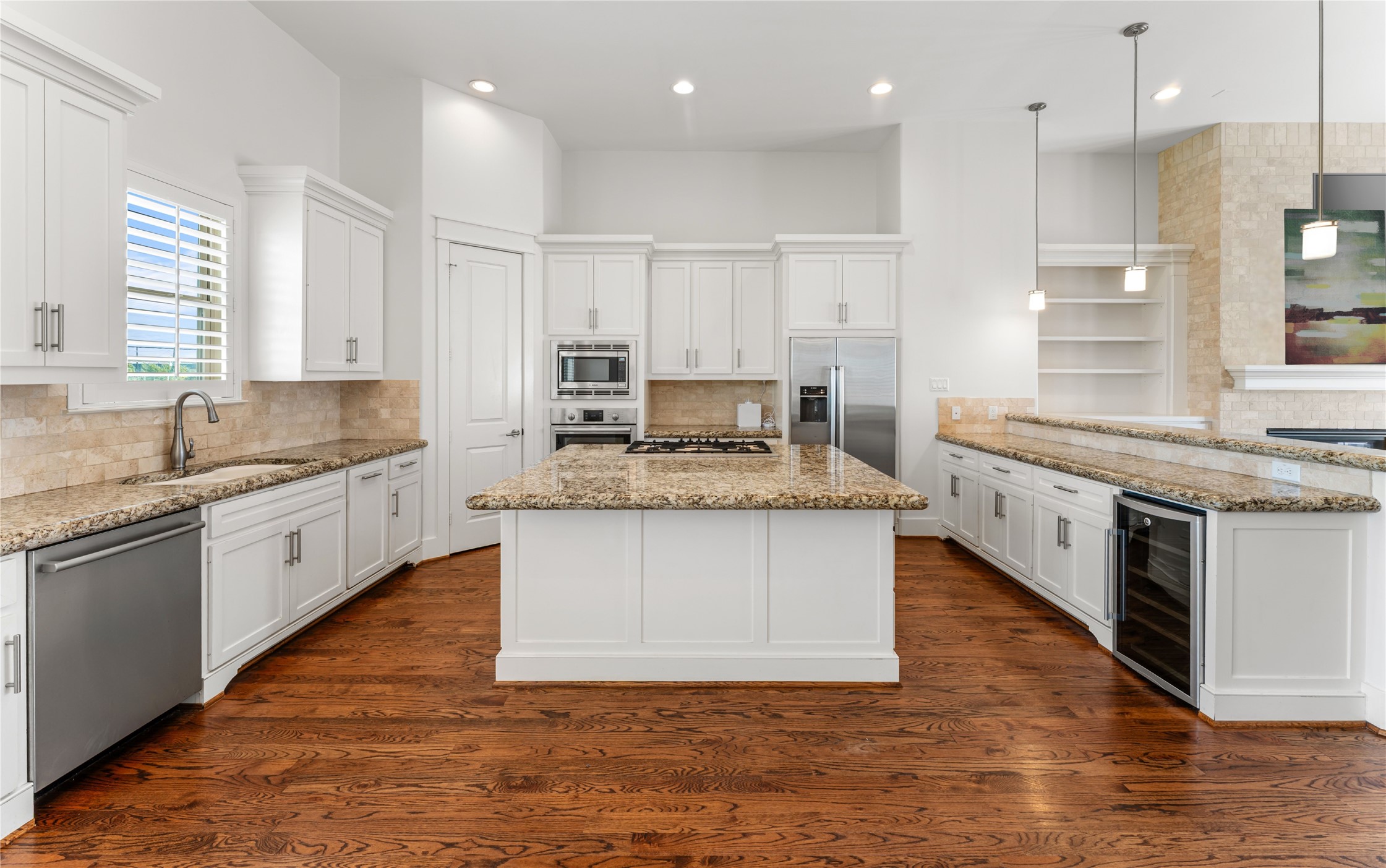 4938 Edison Park Lane Houston, TX 77081 - Photo 14 of 49 a large kitchen with kitchen island granite countertop a stove a sink a counter space and stainless steel appliances