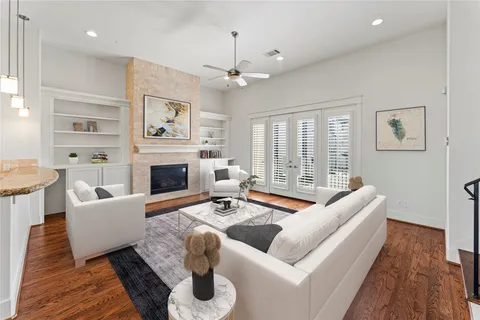 a living room with furniture fireplace and a large window