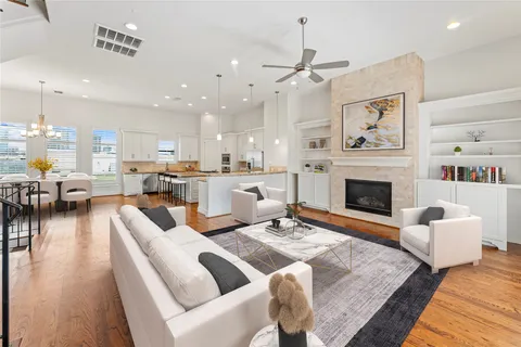 a living room with furniture fireplace and kitchen view