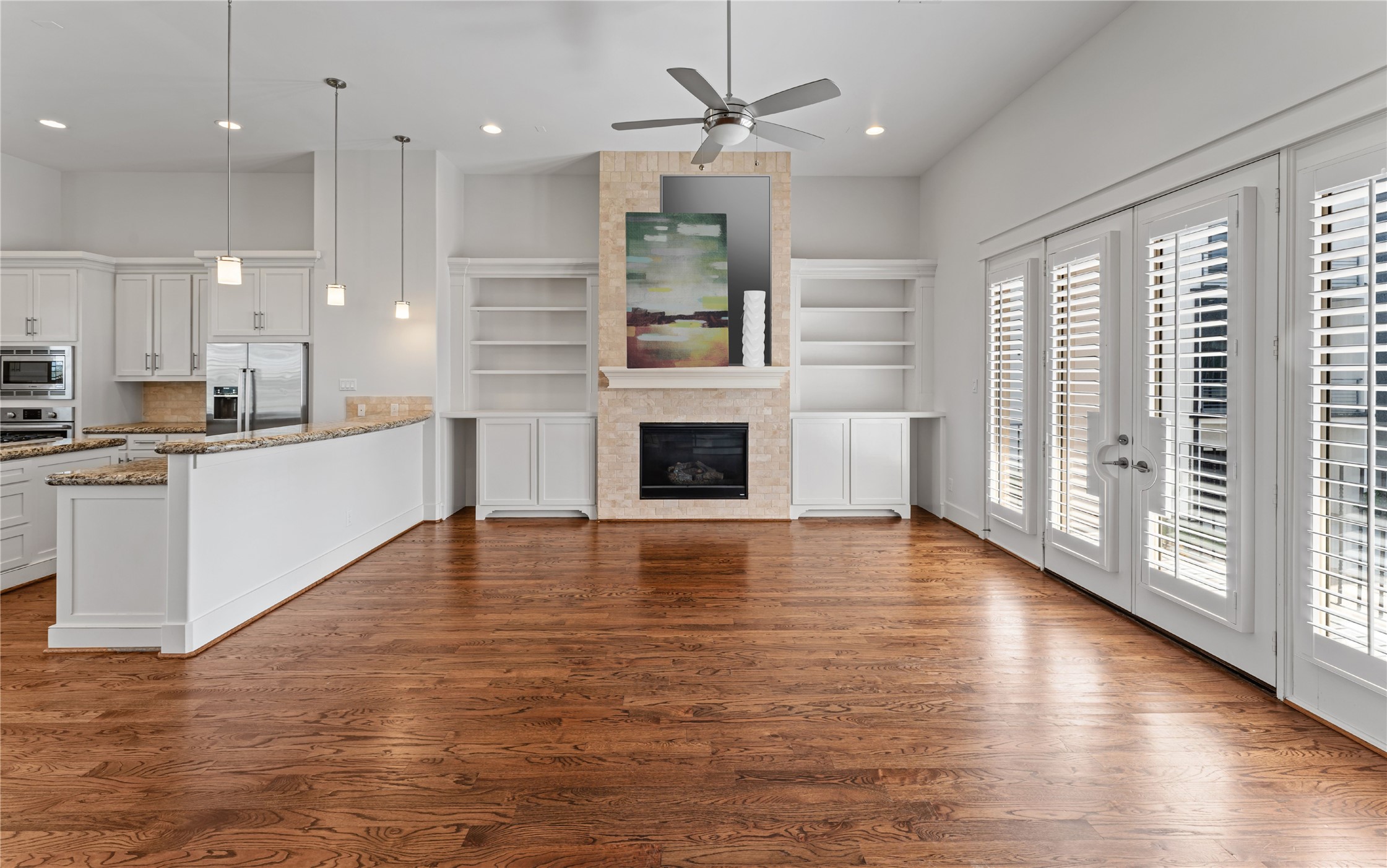 4938 Edison Park Lane Houston, TX 77081 - Photo 24 of 49 a view of a kitchen with kitchen island stainless steel appliances wooden floor and a large window