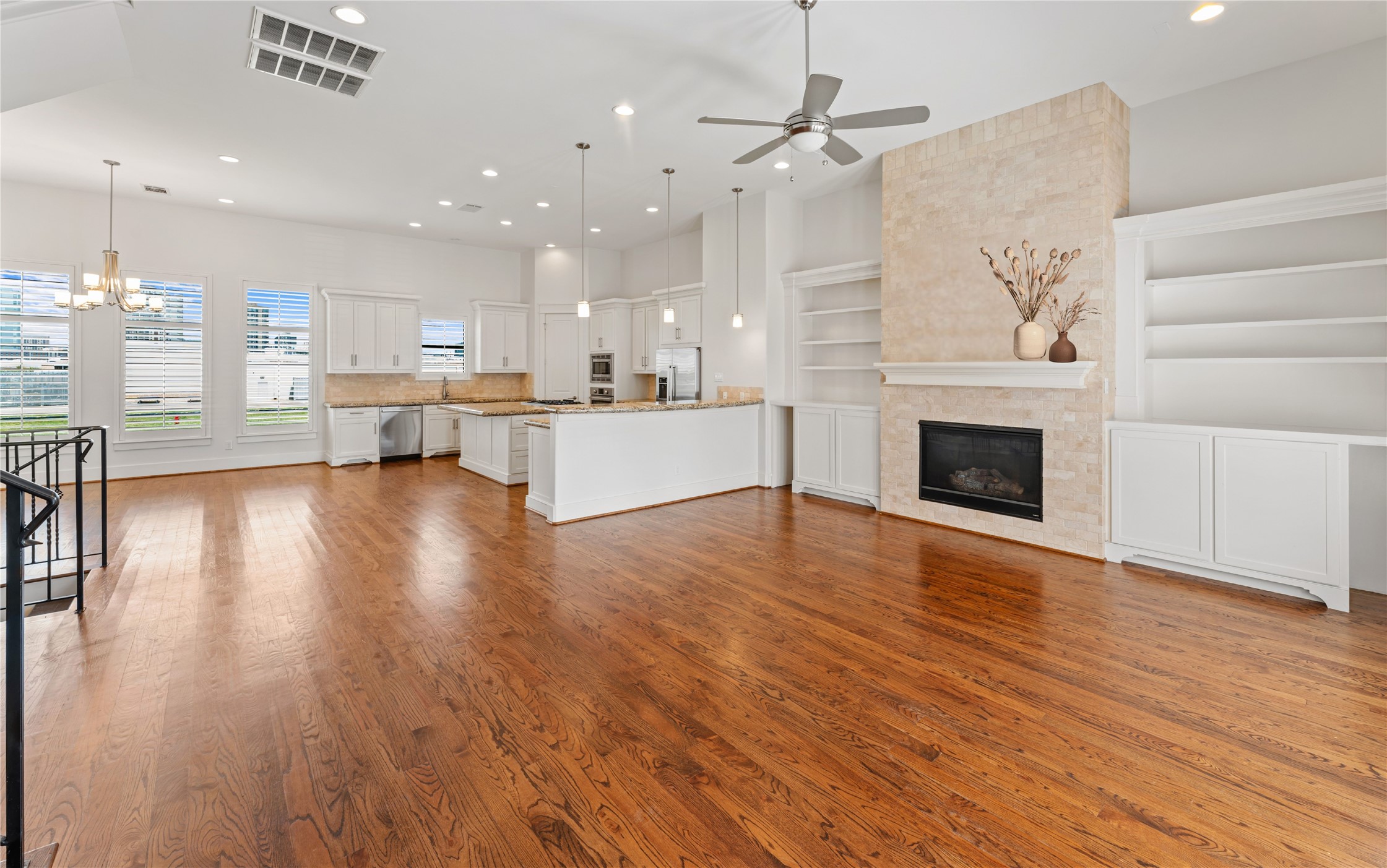 4938 Edison Park Lane Houston, TX 77081 - Photo 25 of 49 a living room with stainless steel appliances furniture a fireplace and wooden floor