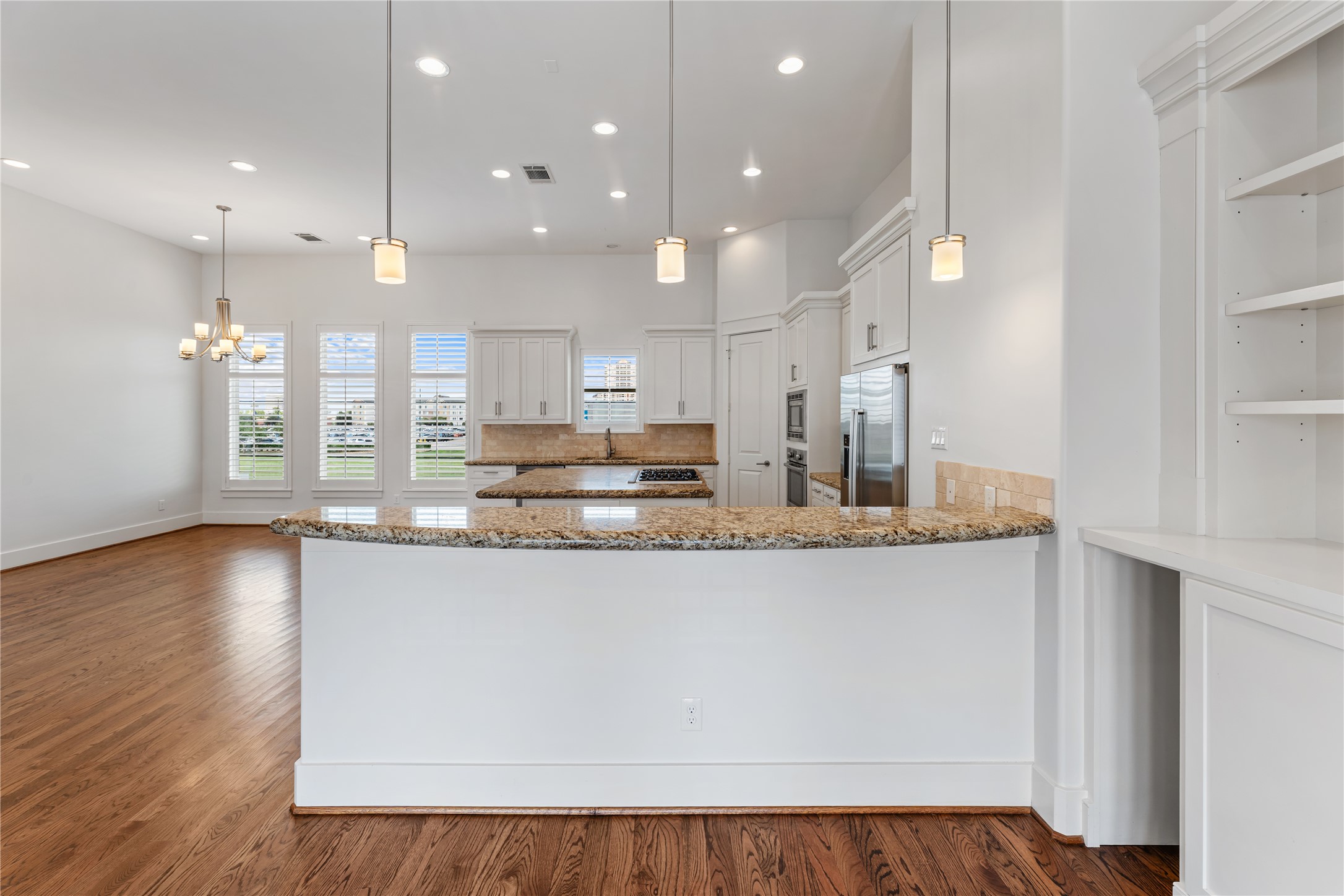 4938 Edison Park Lane Houston, TX 77081 - Photo 28 of 49 a view of kitchen with stainless steel appliances granite countertop cabinets and wooden floor