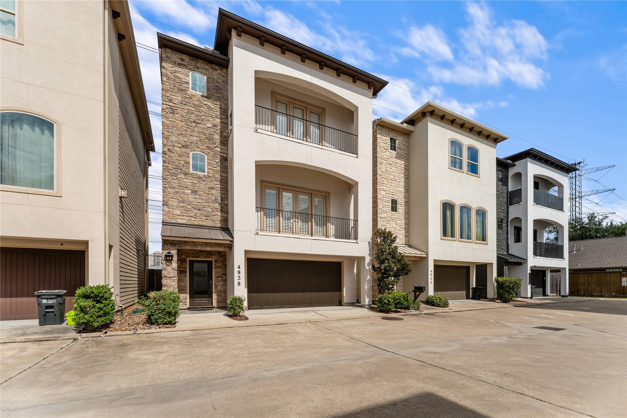 4938 Edison Park Lane Houston, TX 77081 - Photo 3 of 49 a front view of a building with a garden