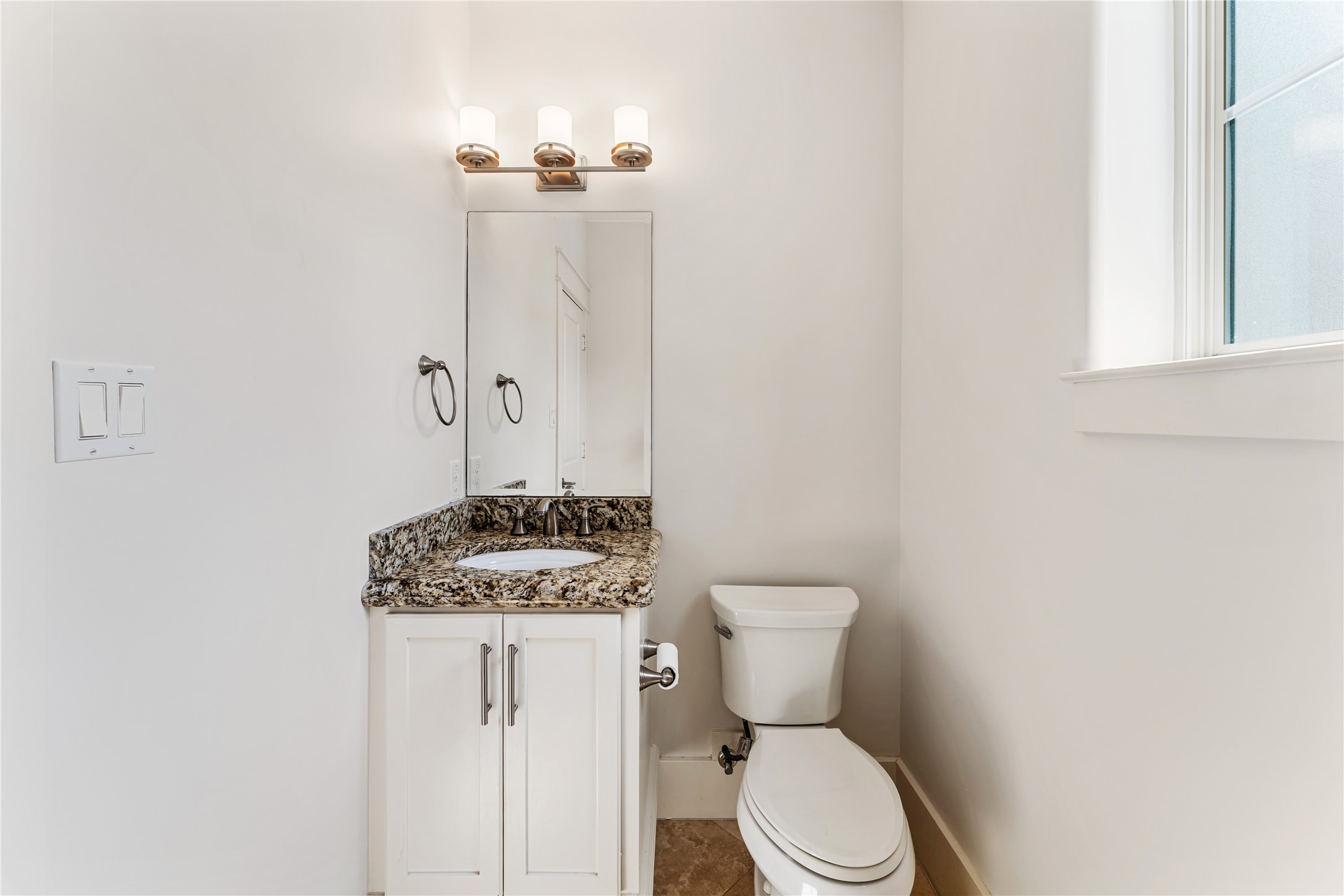 4938 Edison Park Lane Houston, TX 77081 - Photo 31 of 49 a bathroom with a toilet a sink and mirror