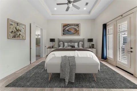 a bedroom with a large bed and a chandelier