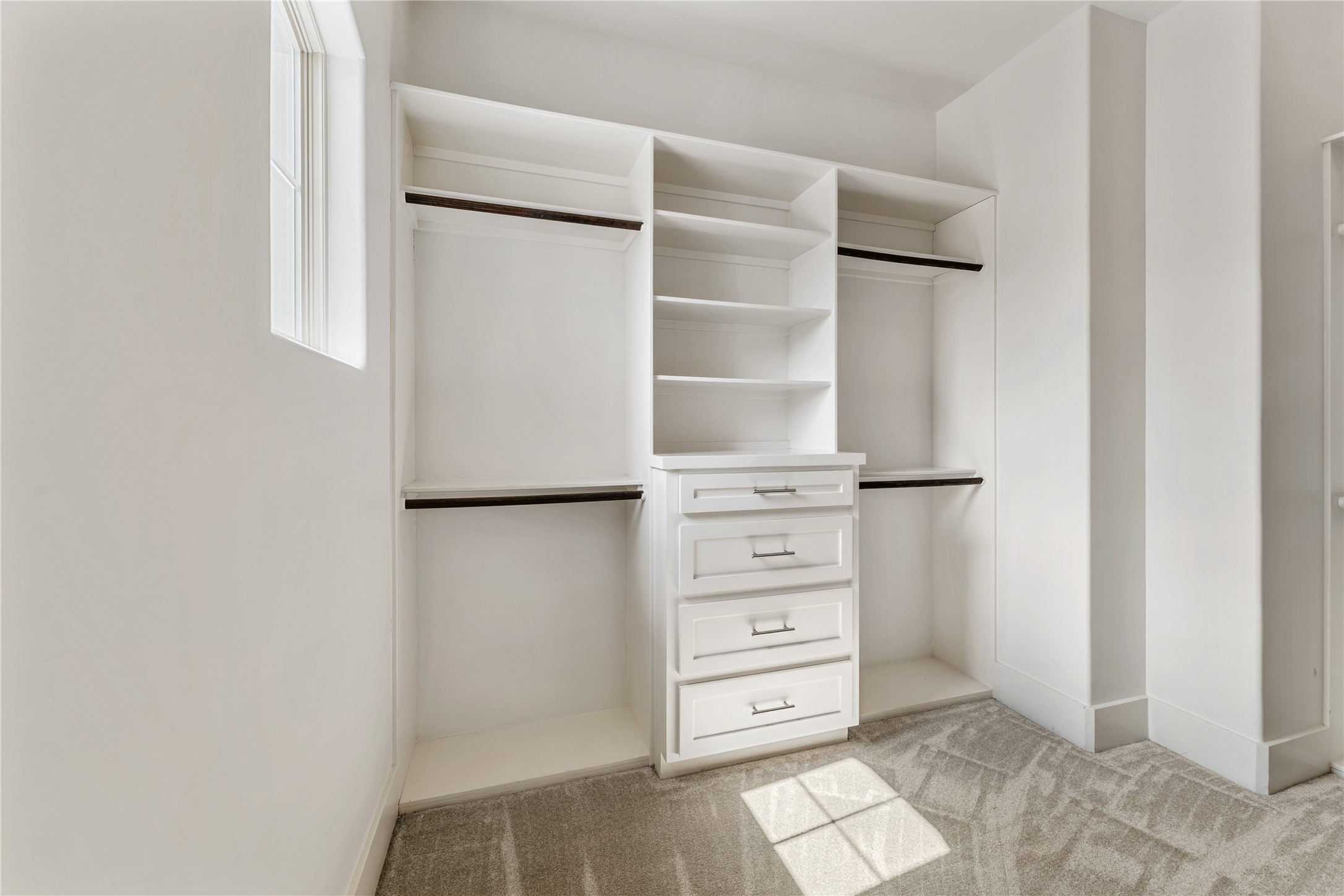 4938 Edison Park Lane Houston, TX 77081 - Photo 37 of 49 a view of walk in closet with empty racks
