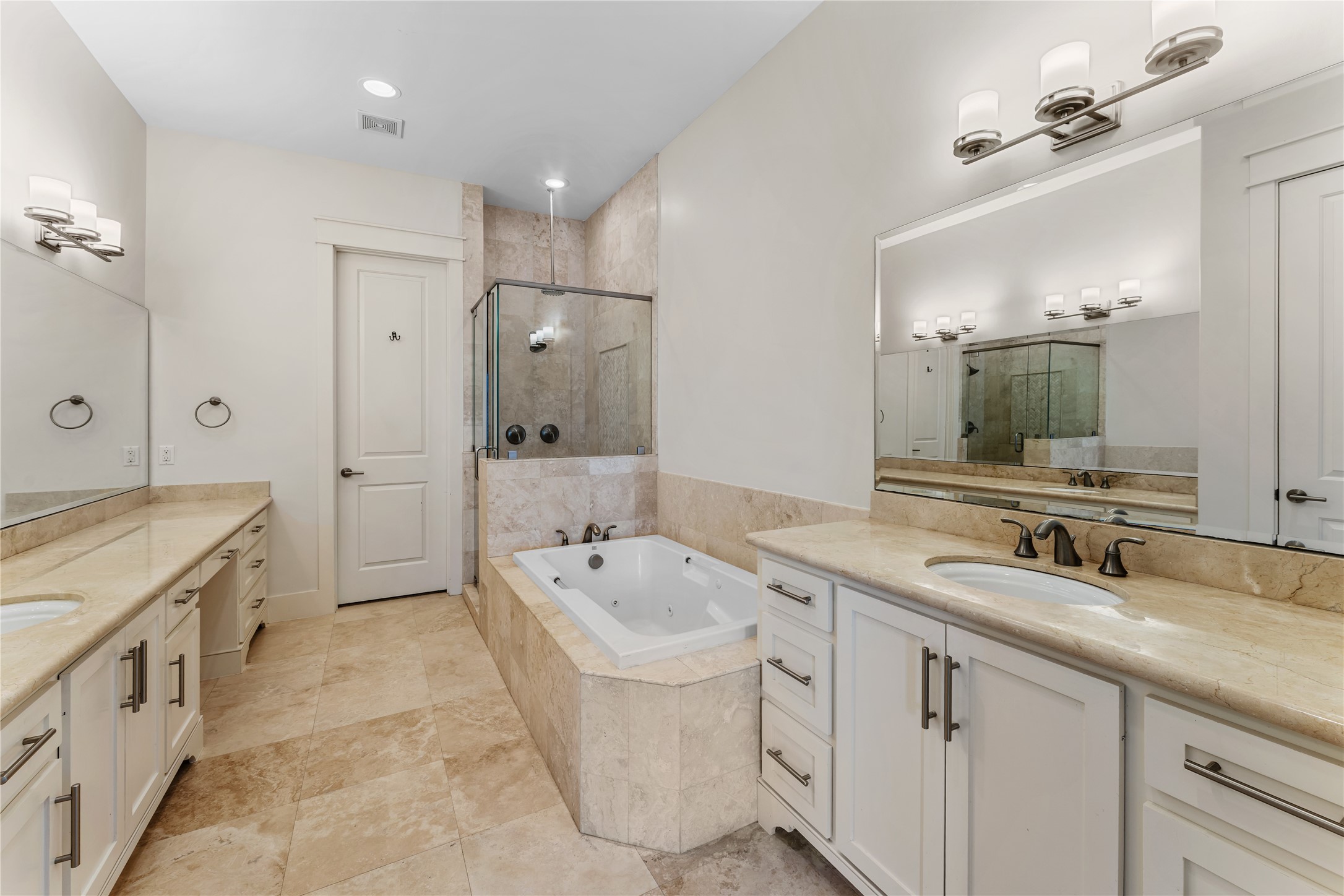 4938 Edison Park Lane Houston, TX 77081 - Photo 40 of 49 a spacious bathroom with a double vanity sink mirror double and bathtub