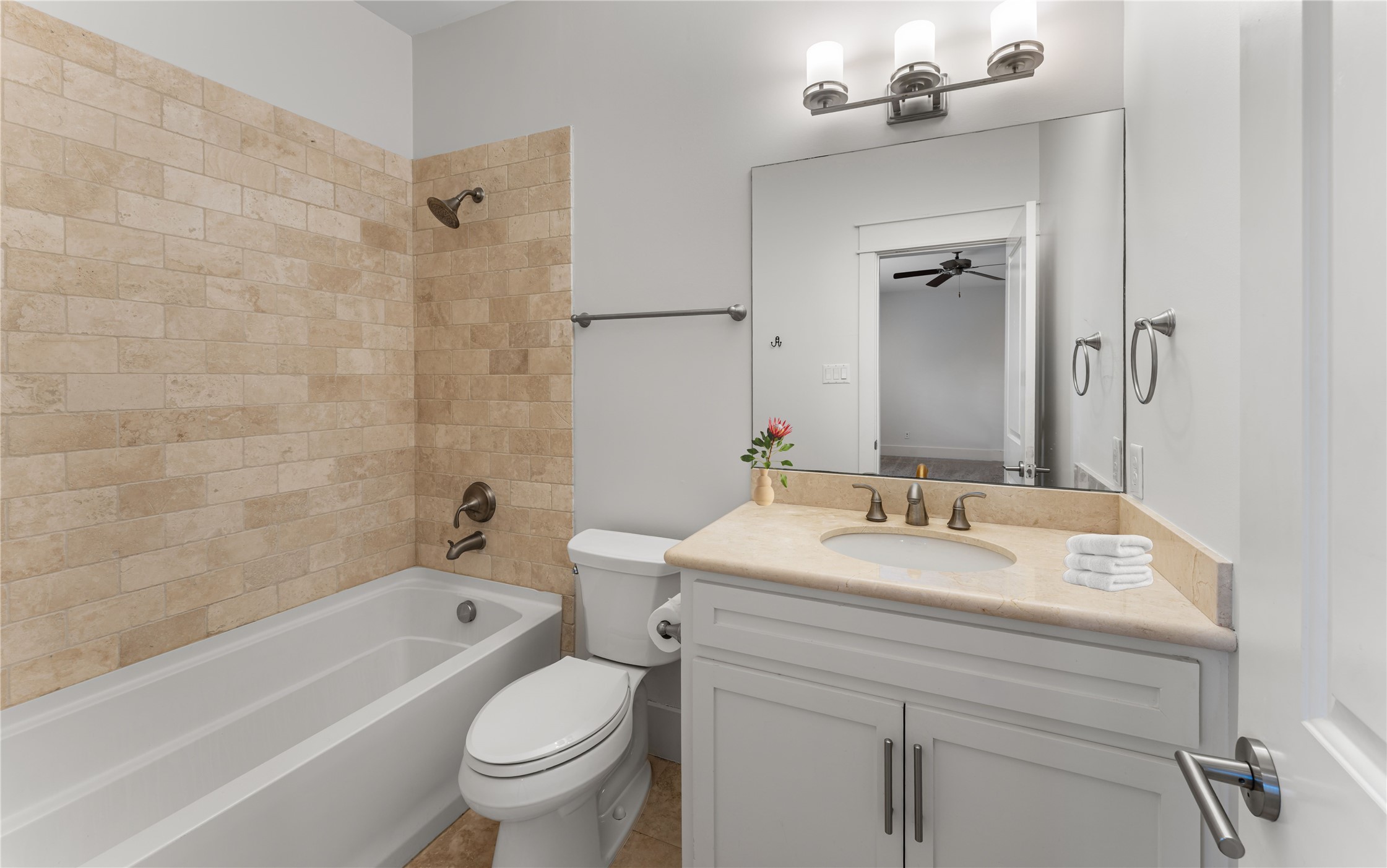 4938 Edison Park Lane Houston, TX 77081 - Photo 4 of 49 a bathroom with a sink a toilet and a bathtub