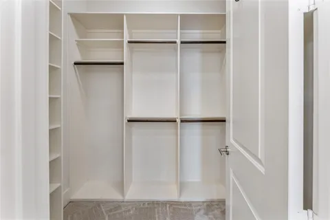 a view of closet area with empty racks