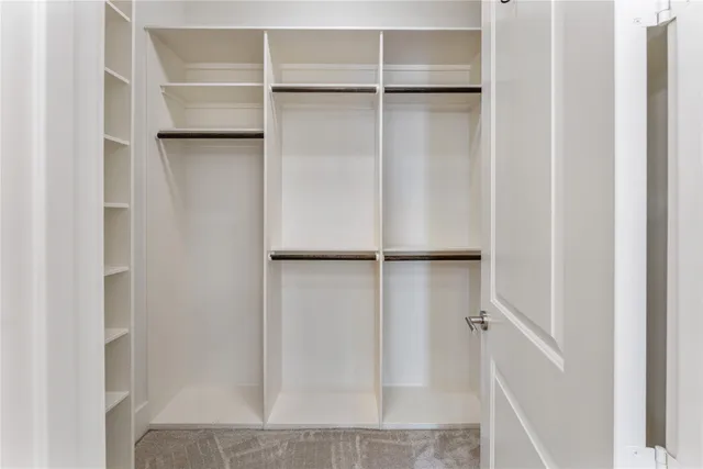 a view of closet area with empty racks