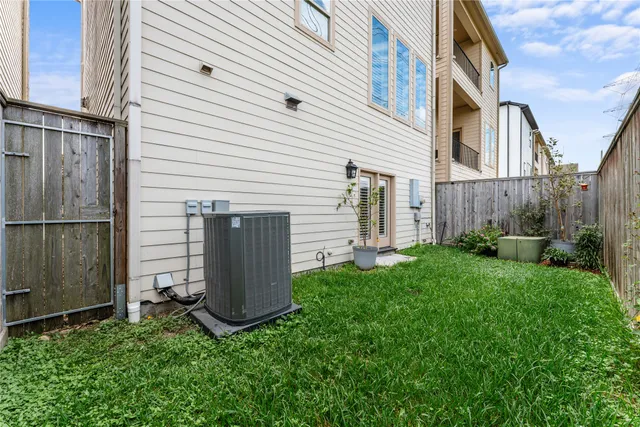 a view of backyard with potted plants and a wooden fence