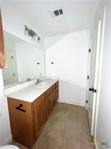 a utility room with cabinets washer and dryer