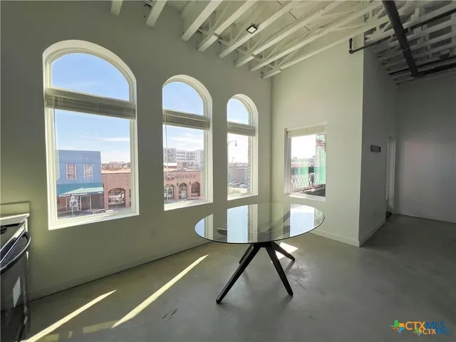 a view of a room with window and furniture