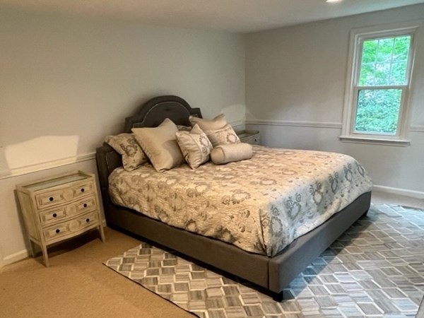 3 Chatham Circle Hingham, MA 02043 - Photo 15 of 36 a bed sitting in a bedroom next to a window