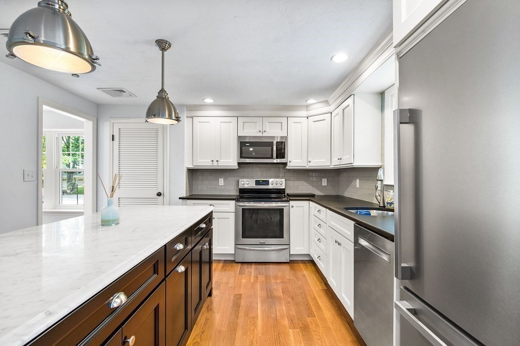 3 Chatham Circle Hingham, MA 02043 - Photo 17 of 36 a kitchen with stainless steel appliances granite countertop a stove a sink and a refrigerator