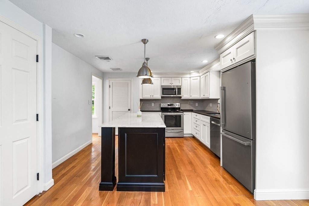 3 Chatham Circle Hingham, MA 02043 - Photo 18 of 36 a kitchen with granite countertop stainless steel appliances a refrigerator cabinets and wooden floor