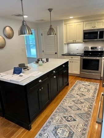 3 Chatham Circle Hingham, MA 02043 - Photo 2 of 36 a kitchen with a sink stove and microwave